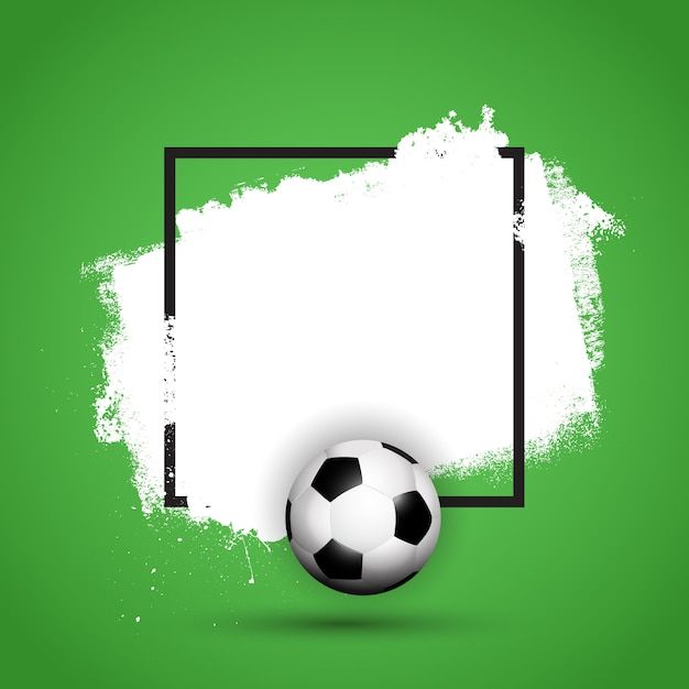 a soccer ball sitting on top of a green field next to a black and white frame