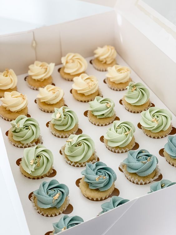 a box filled with cupcakes covered in frosting