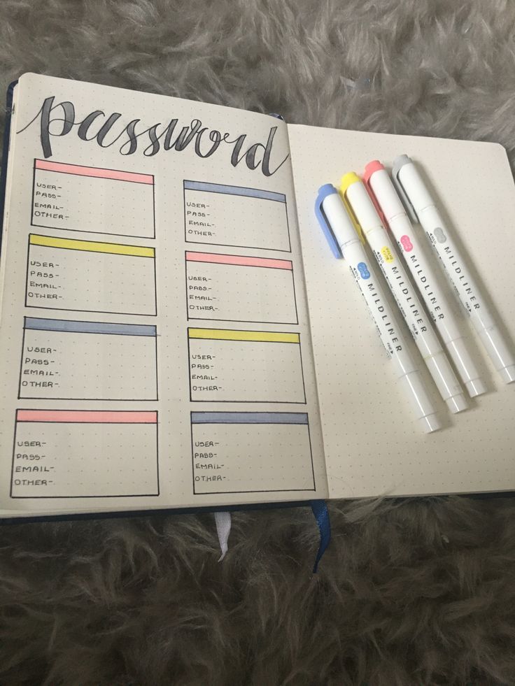 an open notebook with three pens on top of it and the word'password'written in cursive writing