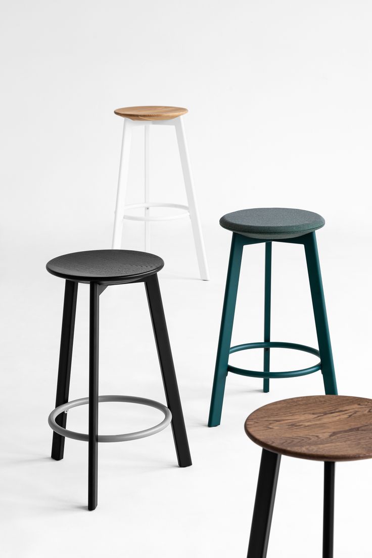 three stools in different colors and sizes, one with a wooden seat on the other