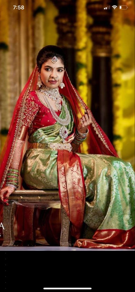 a woman in a red and green dress sitting on a chair