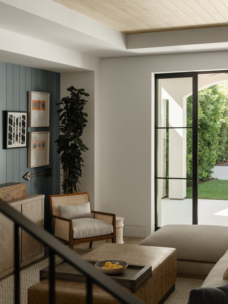 a living room filled with furniture and a sliding glass door