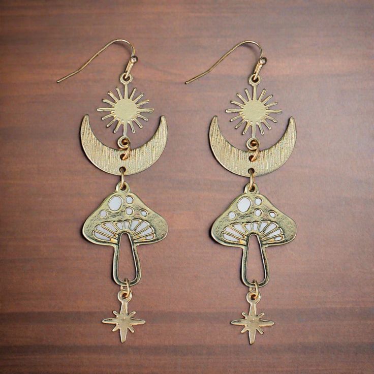 Description These gorgeous celestial boho earrings are sure to add an air of mystery! Lightly textured gold linear earrings include star, moon and mushroom pieces linked together to create a heavenly dramatic earring. Details FROM ZAD sacred symbol gold earrings measures 3x1" Gold Tone Metal Features One of a kind, fashion jewelry, everyday jewelry Great gift for that special girl, anniversary gift, birthday gift or gift to say how much you care. Check out the rest of our store for other great p