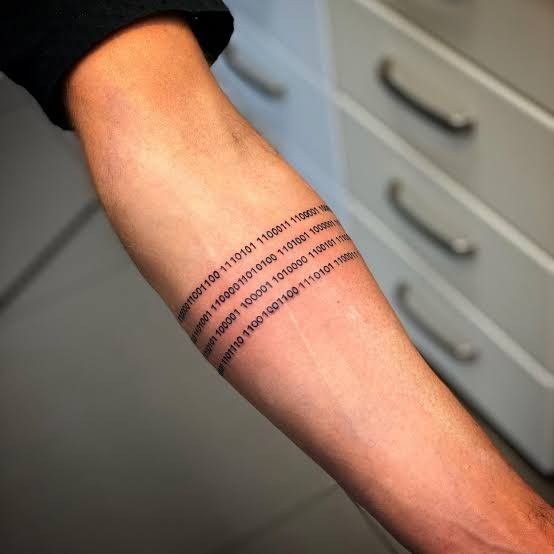 a person with a tattoo on their arm that has words written in different languages and numbers