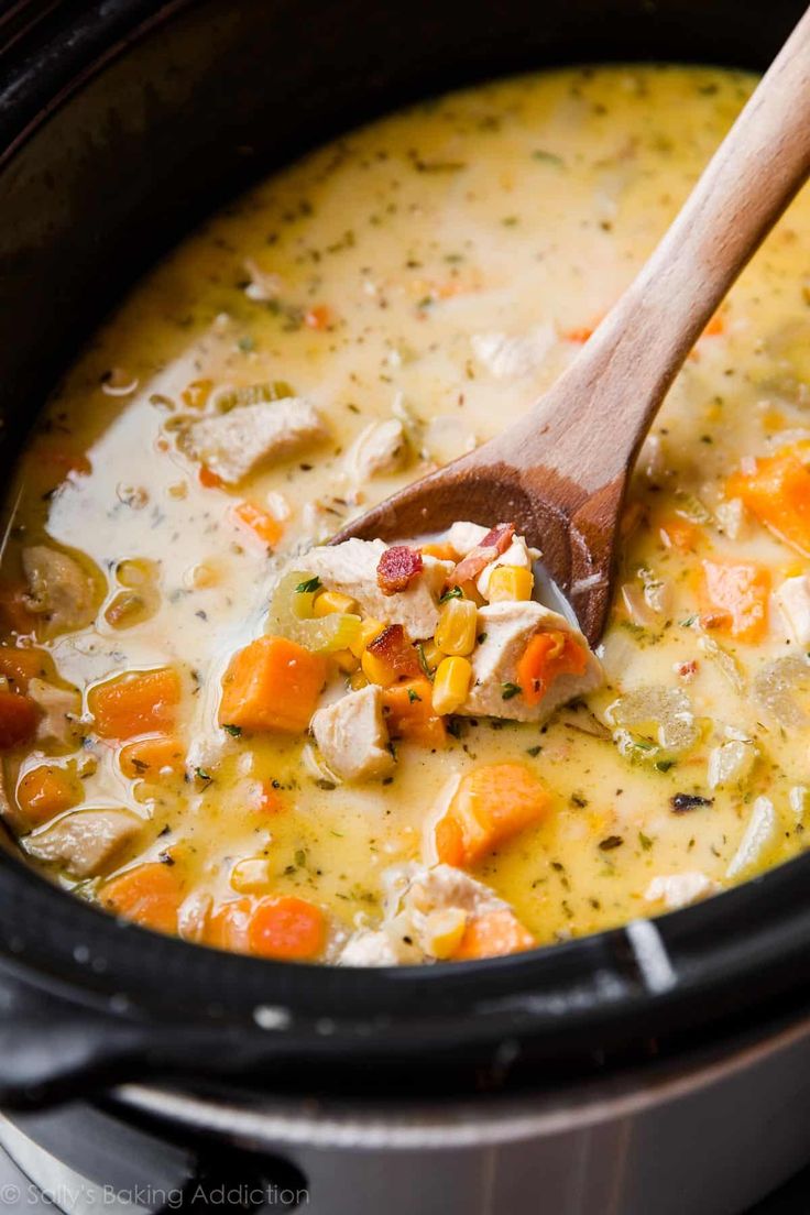 a wooden spoon in a pot filled with soup