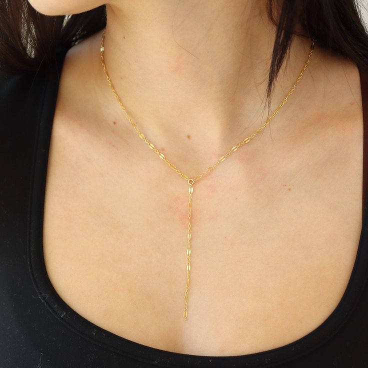 Our Sylvie Lariat is peak luxe feminine vibes! Using one of our best sellers, the Sylvie Chain, this lariat is a show stopping deviation from a classic chain necklace with its 3" drop. Pair this delicate chain with our Luxe Herringbone to create a fun stack. DETAILSOffered in 14", 16", or 18" lengths, with 3" lariat hanging downAvailable in 14k Gold Fill and Sterling SilverHypoallergenic, Nickel-Free, and Water Safe Delicate 14k Gold Filled Lariat Jewelry, Dainty Long Drop Lariat Necklace With Delicate Chain, Delicate Long Drop Lariat Necklace With Delicate Chain, Dainty Lariat Drop Necklace With Adjustable Length, Dainty Lariat Drop Necklace With Delicate Chain, Dainty Lariat Drop Necklace With Clavicle Chain, Delicate Long Drop Lariat Necklace, Dainty Lariat Charm Necklace With Delicate Chain, Minimalist Clavicle Chain Lariat Necklace