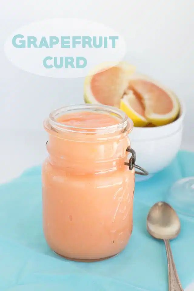 a glass jar filled with liquid sitting on top of a table next to a spoon