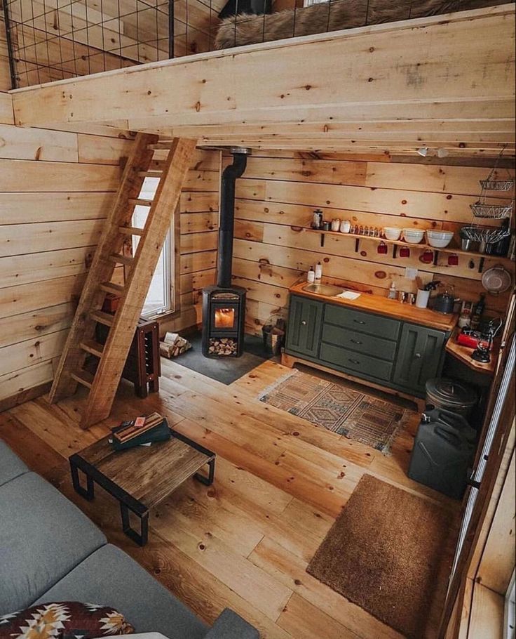 a living room filled with furniture and a fire place in the middle of a loft