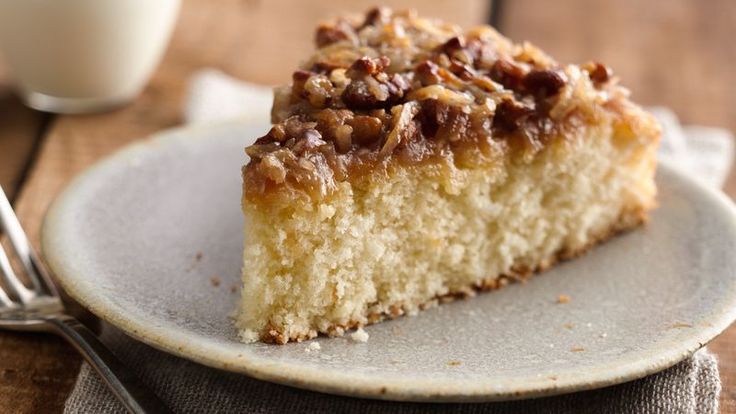 a piece of cake sitting on top of a white plate next to a glass of milk