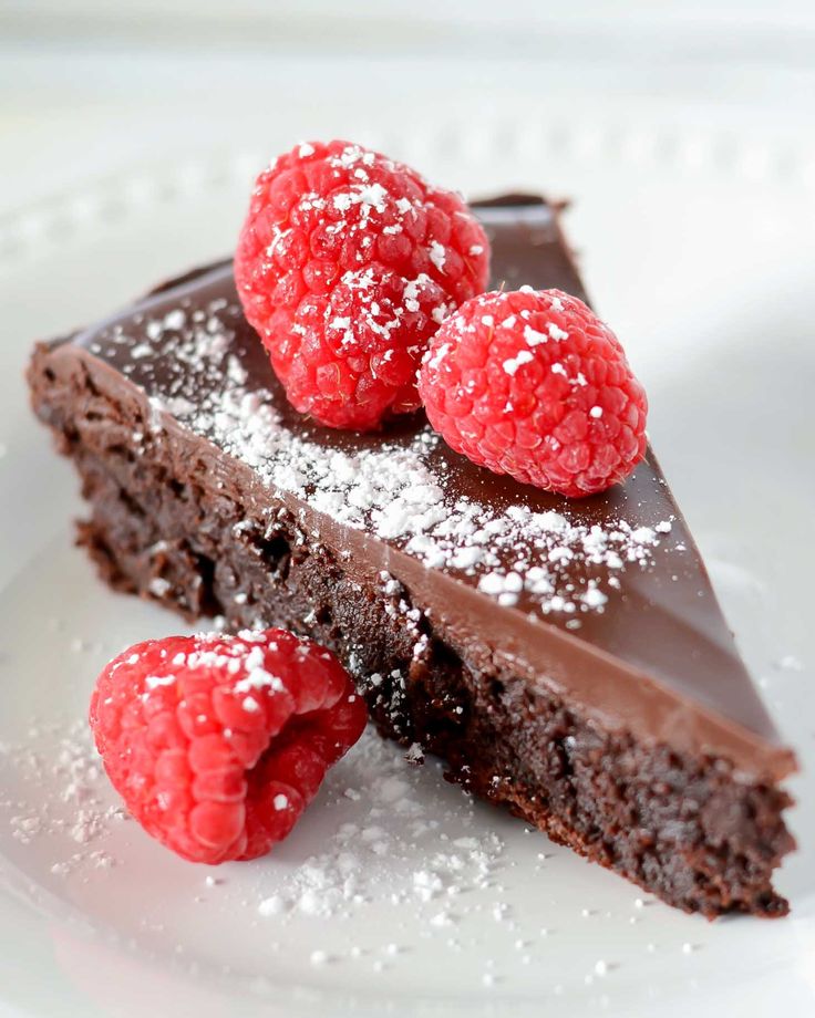 a piece of chocolate cake with raspberries on top