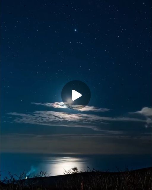 the night sky is full of stars and clouds, with a video player in the foreground