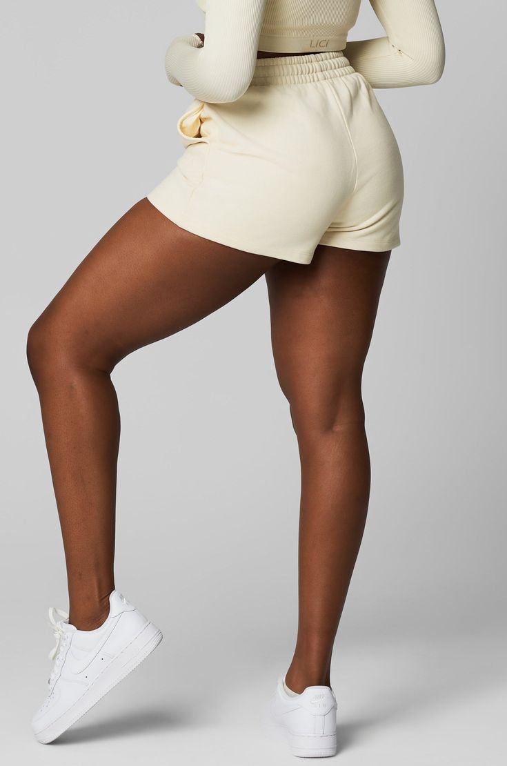 Get a perfectly laid-back look with these Heavy Cotton Sweat Short. Features a drawstring at the waist, side pockets, and a finished hem. Say hello to a new forever fave, these shorts have an oversized fit and embroidered LiCi logo at pocket. Style with our matching Crop Zip Hoodie. Fits true to size. 100% premium cotton Drawstring waistband LiCi Logo at pocket Short length Size up for a more oversized look Relaxed Fit Drawstring Activewear Shorts, Cotton Activewear With Drawstring Shorts, Short Cotton Activewear With Drawstring, Cotton Activewear With Drawstring And Short Length, Sporty Relaxed Fit Bottoms For Weekend, Relaxed Fit Cotton Athletic Shorts With Functional Drawstring, Relaxed Fit Cotton Athletic Shorts With Drawstring, Beige Relaxed Fit Shorts For Leisure, Shorts With Functional Drawstring For Loungewear