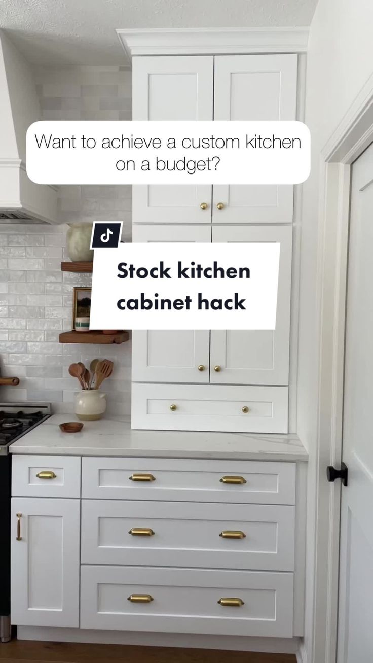 a kitchen with white cabinets and gold pulls on the cabinet doors is featured in an article about how to achieve a custom kitchen on a budget