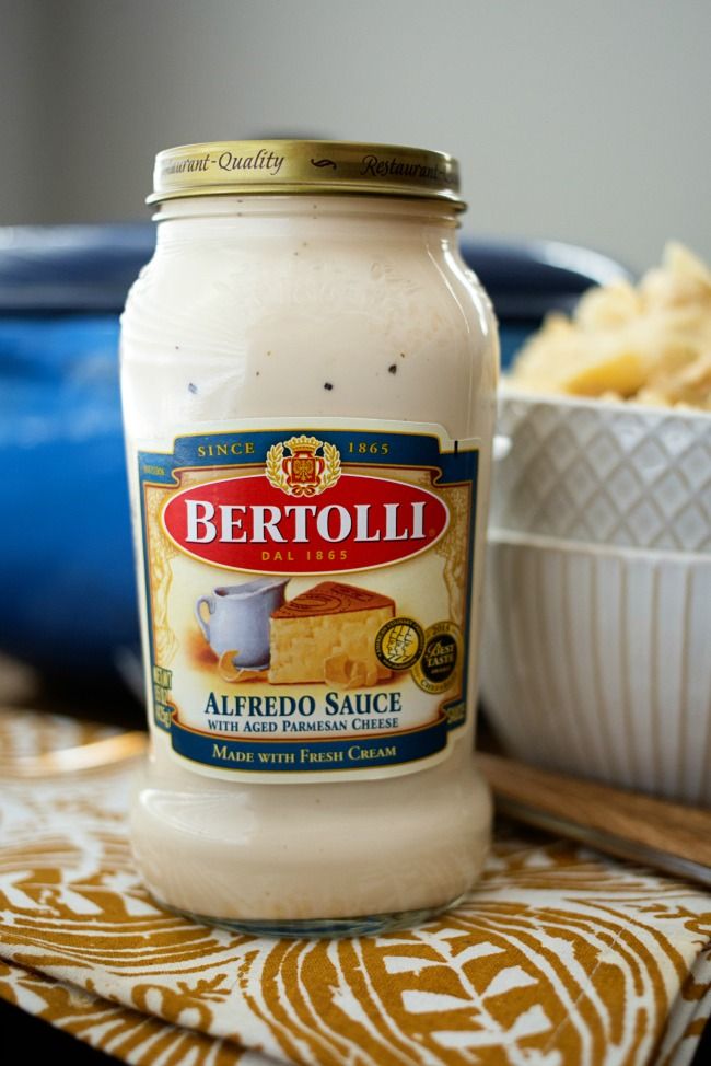 a jar of alfredo sauce sitting on top of a table