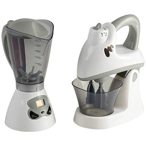 two white blenders sitting next to each other on a white surface with one being used as a juicer