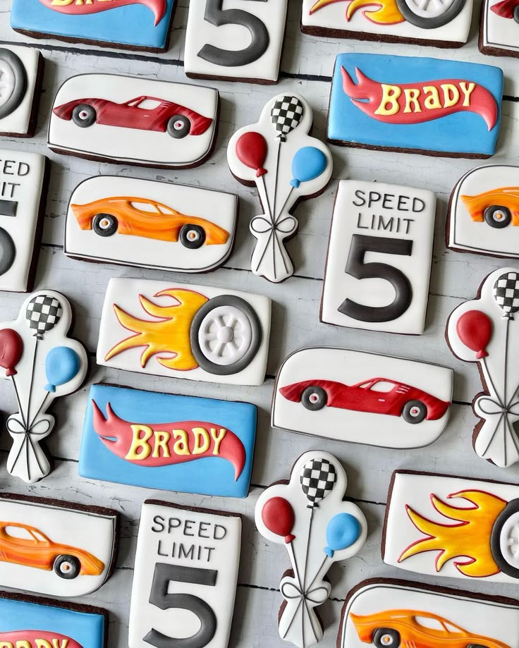 the cookies are decorated like race cars and numbers for birthdays or any special occasion