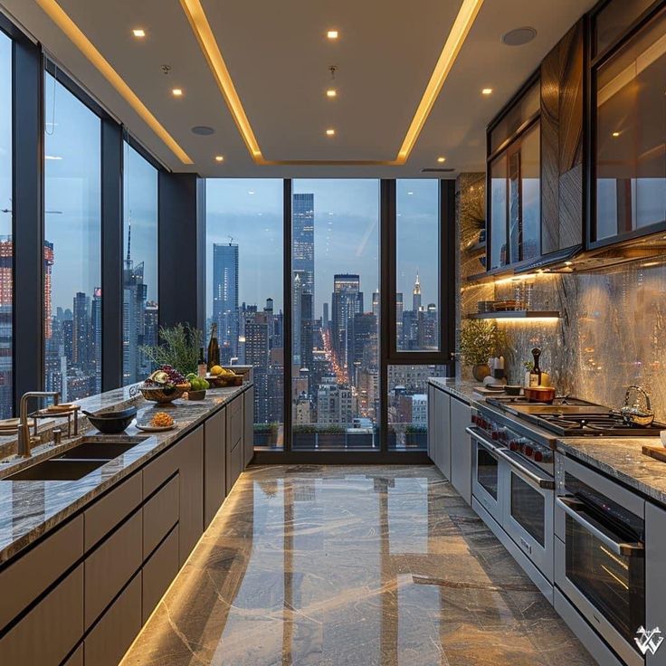 a kitchen with large windows and granite counter tops in front of the cityscape