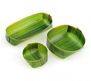 three green leaf shaped dishes on a white surface