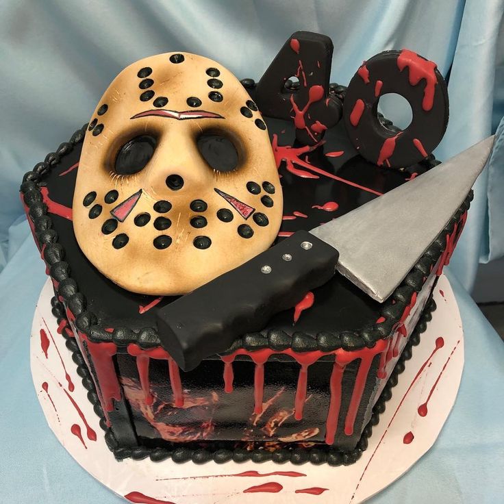 a cake with a knife and mask on it