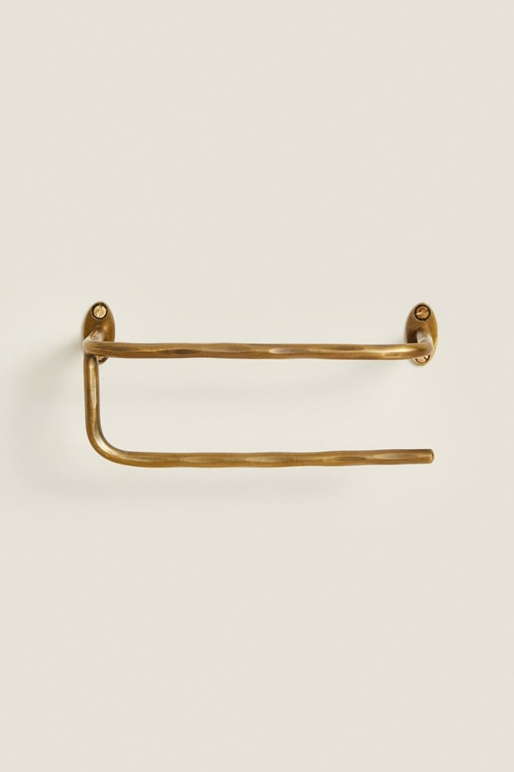 an antique brass towel ring on a white background