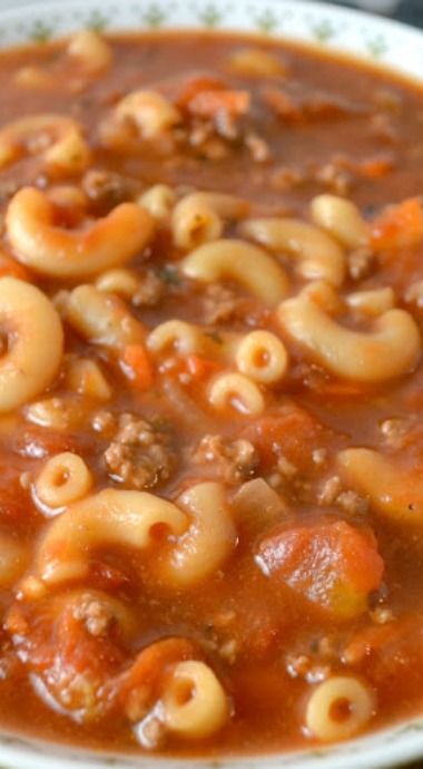 a white bowl filled with pasta and meat soup