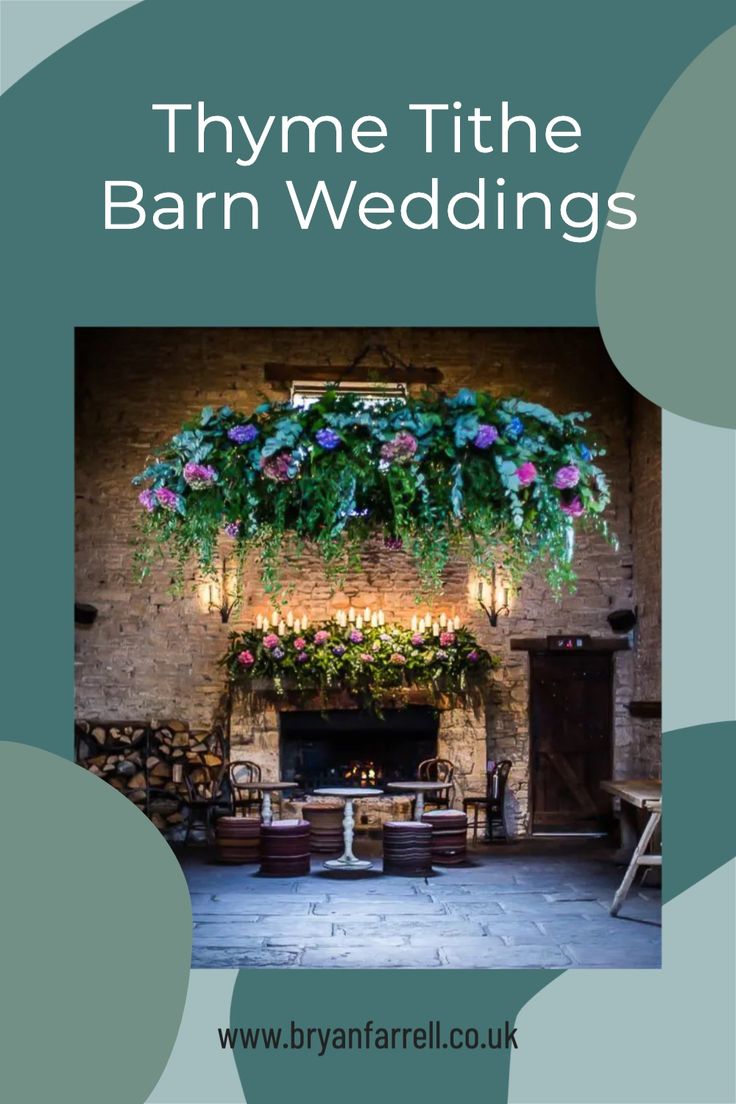 a fireplace with flowers hanging from it and the words thye tithe barn wedding