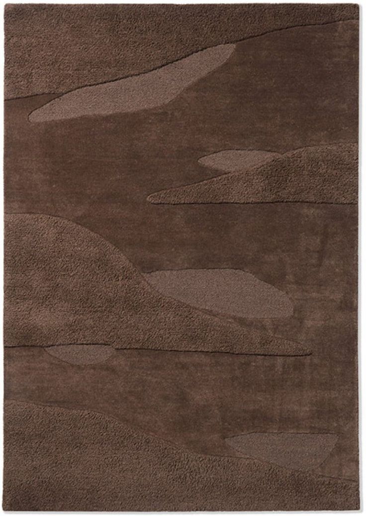 a brown rug with an abstract design on it