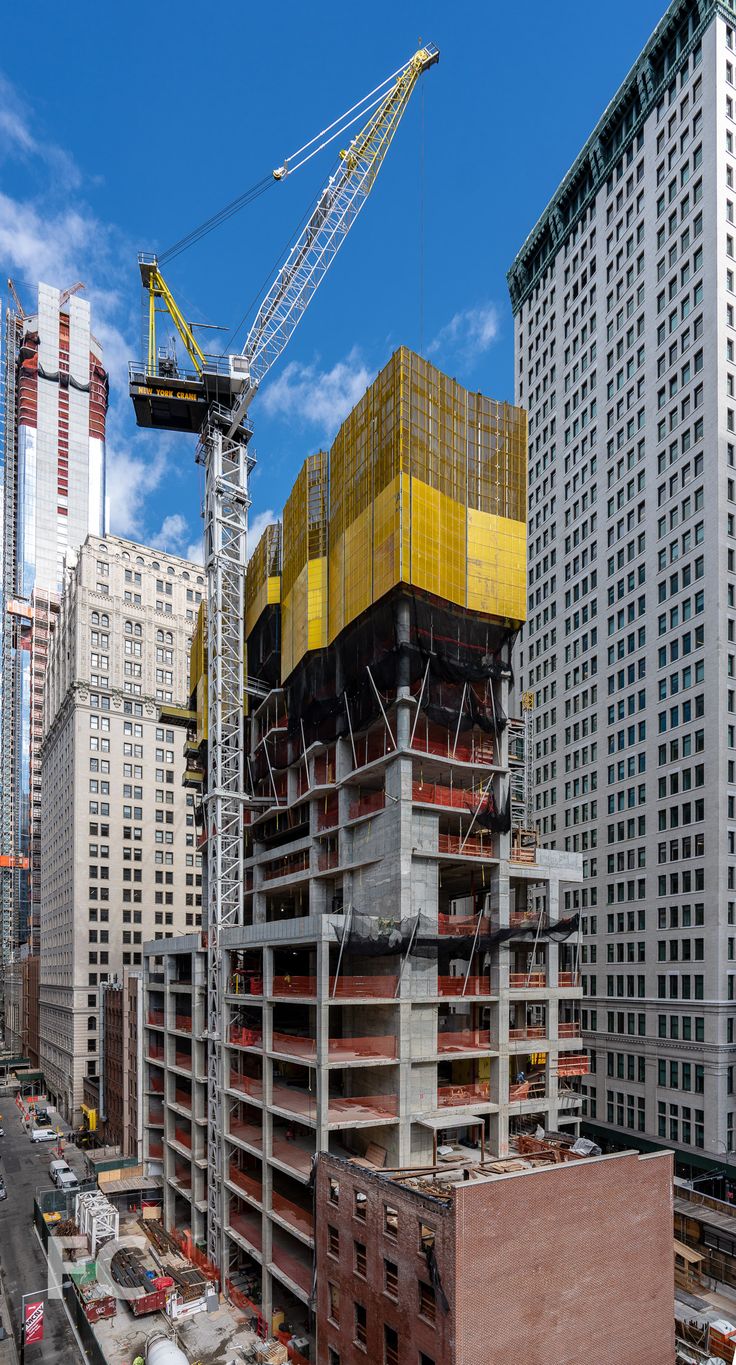 a crane is on top of a building under construction