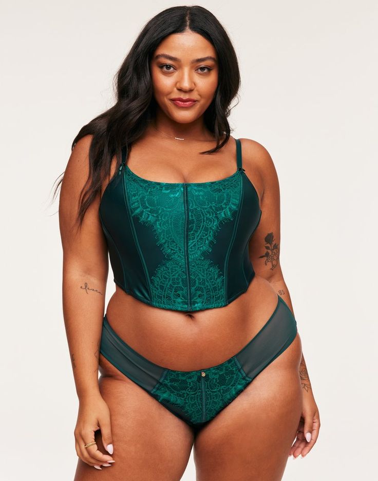 The Geneviève Unlined Corset is a gorgeous combination of green satin and contrast lace. The boned front and back seams will define your curves, with a sweet satin bow at the straps and a matching cheeky panty. It is perfect for any romantic, special occasion. (Available in plus-sizes XL-4X.) Cropped Corset, Adore Me, Satin Bow, Bustier Top, Green Satin, Night Looks, Lingerie Set, Women Lingerie, Dark Green