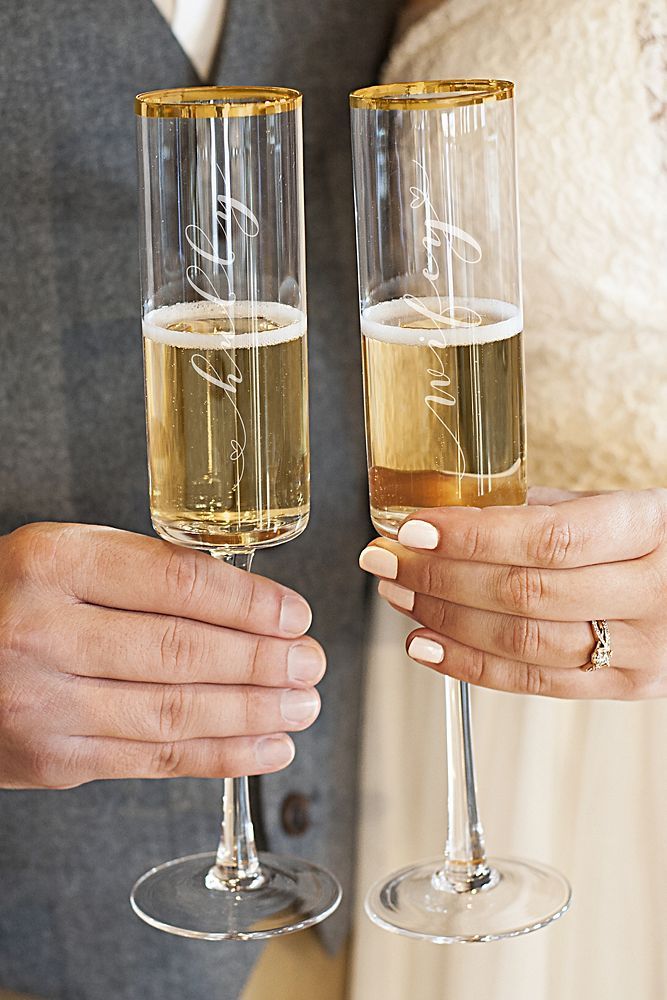 two people holding wine glasses in their hands