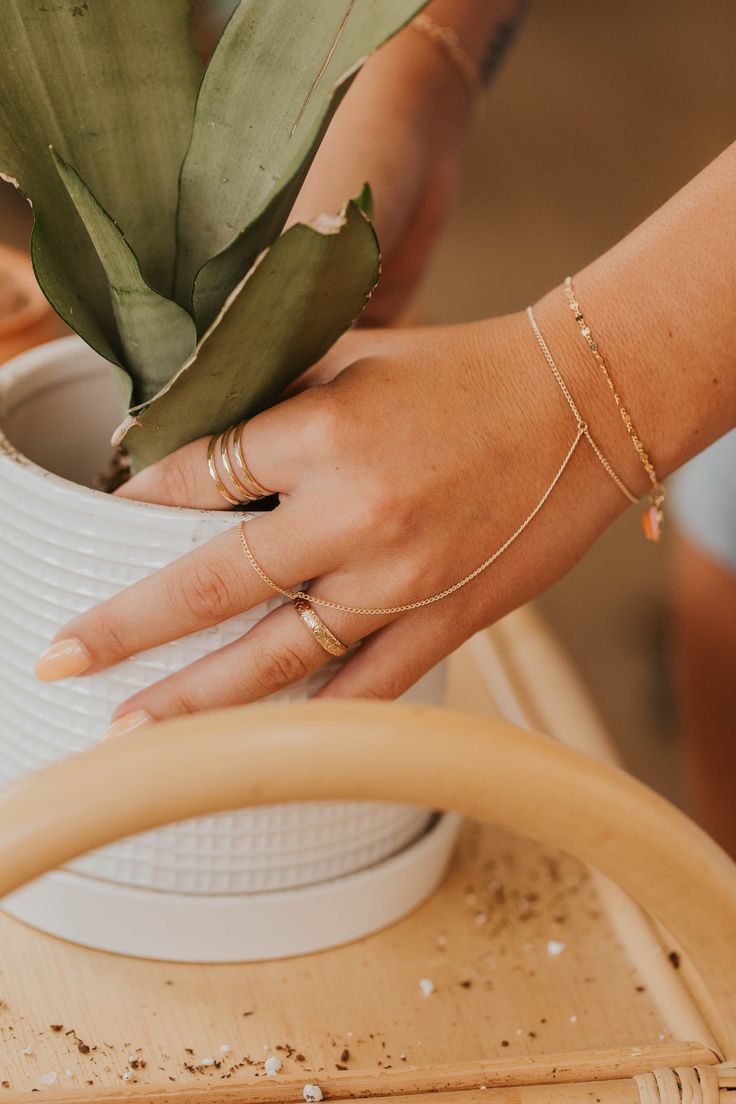 Channel your inner bohemian with this hand chain that loosely drapes around your finger and wrist. Whether you’re at a music festival or brunch with the girls, this hand candy turns any outfit into magic. Bracelet is 6" with a 1" extender. S/M: ring size 5-7.5, wrist size 6-7" M/L: ring size 8-10.5, wrist size 7-7.5" Available in 14kt Gold Fill + Sterling Silver. Handmade in Eau Claire, WI. Our jewelry is handmade so each piece will be unique and may vary slightly from what is pictured. Magic Bracelet, M Ring, L Ring, Hand Candy, Hand Chain, 14kt Gold, Music Festival, Gold Filled, Ring Size