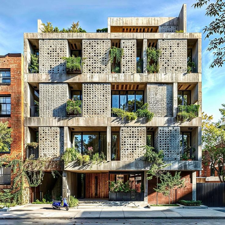 an apartment building with plants growing on the balconies