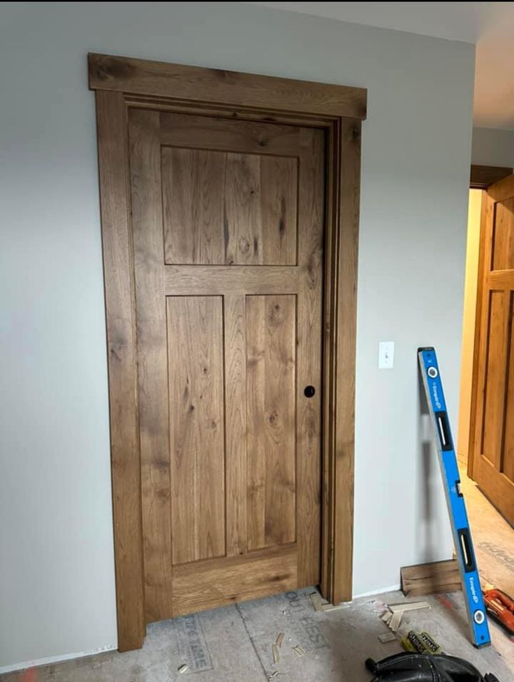 a wooden door being installed in a room