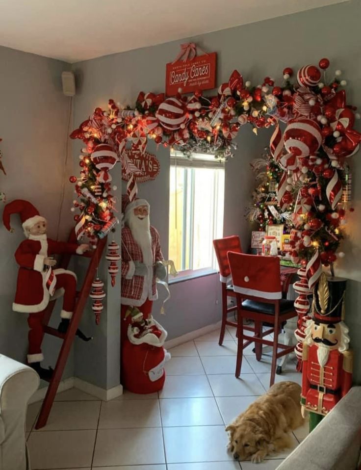 a living room decorated for christmas with santa clause decorations