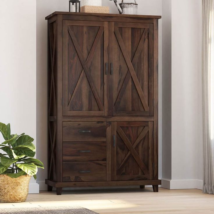 a tall wooden cabinet sitting next to a potted plant