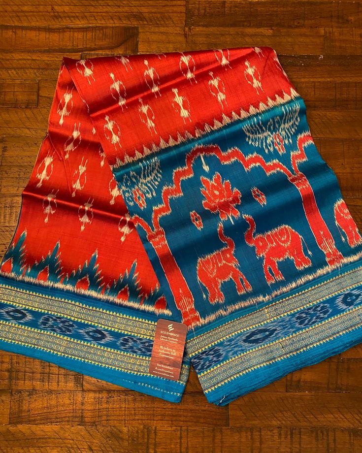 two red and blue sari with elephants on them