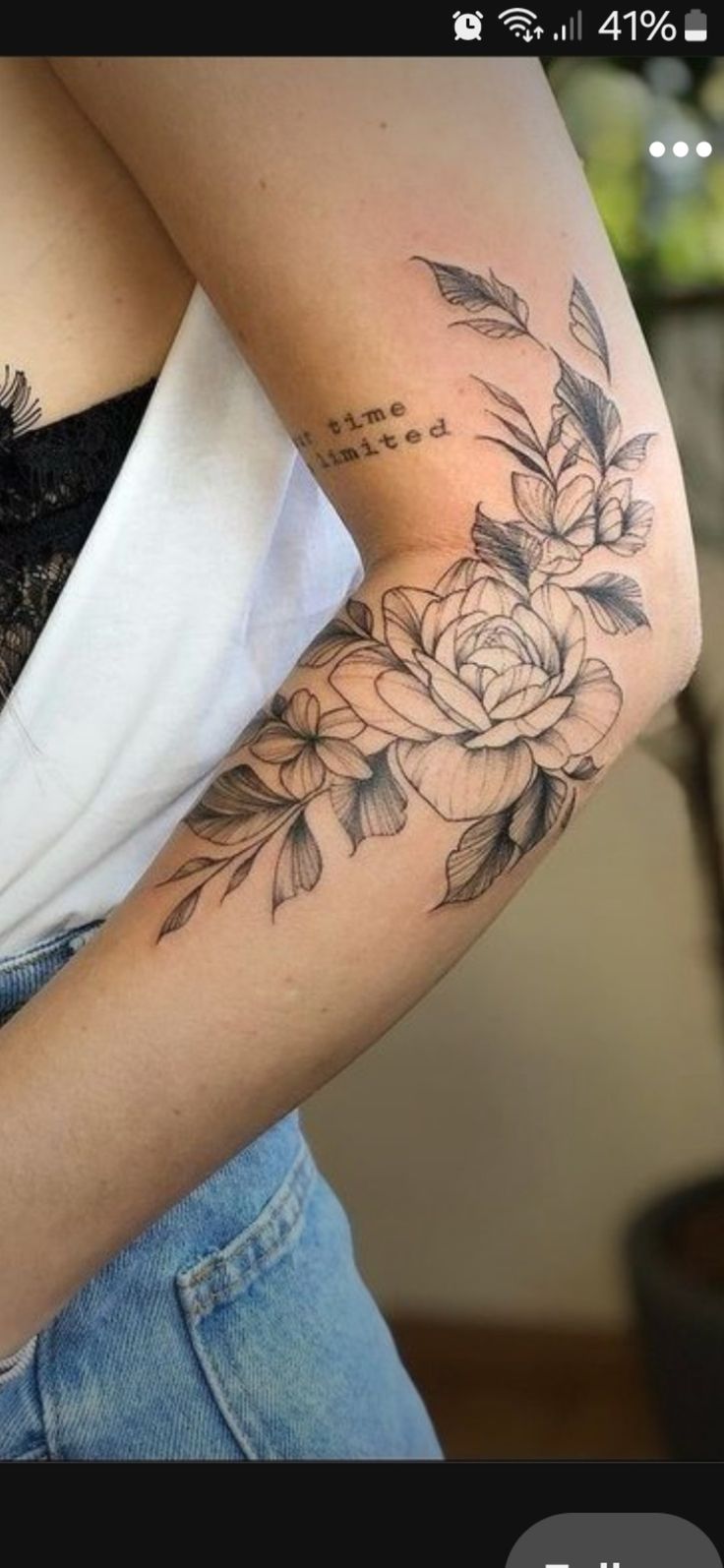 a woman with a flower tattoo on her arm