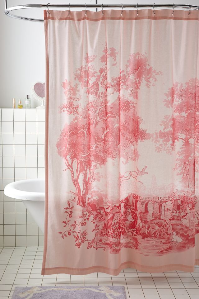 a bathroom with a shower curtain that has pink trees on it and white tile flooring