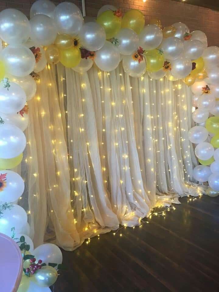 a room with balloons and lights on the wall