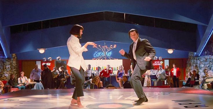 two people are dancing on the dance floor in front of an audience at a convention