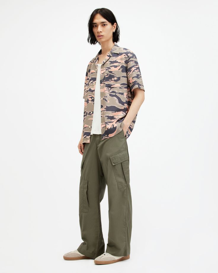 We're looking back. The Verge Pants are inspired by vintage cargo pants. Carefully crafted with an organic cotton fabric, the silhouette is wide in the leg and relaxed fitting. Complete with angled patch on the side and a further five throughout the trouser, they keep things authentic. Laidback styling, sorted.  Button fly closure Wide straight leg Mid-rise Vintage-inspired Angled side patch pockets Front welt pockets Back flap pockets Regular length Spring Military Style Cotton Cargo Jeans, Military Style Relaxed Fit Wide Leg Parachute Pants, Khaki Wide-leg Cargo Jeans With Patch Pockets, Military Wide Leg Cotton Cargo Jeans, Khaki Wide Leg Cargo Jeans With Patch Pockets, Wide Leg Khaki Cargo Jeans With Patch Pockets, Relaxed Fit Wide Leg Military Cargo Jeans, Urban Cotton Parachute Pants With Flap Pockets, Khaki Cotton Parachute Pants With Flap Pockets