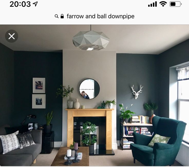 a living room filled with furniture and a fire place in front of a mirror on the wall