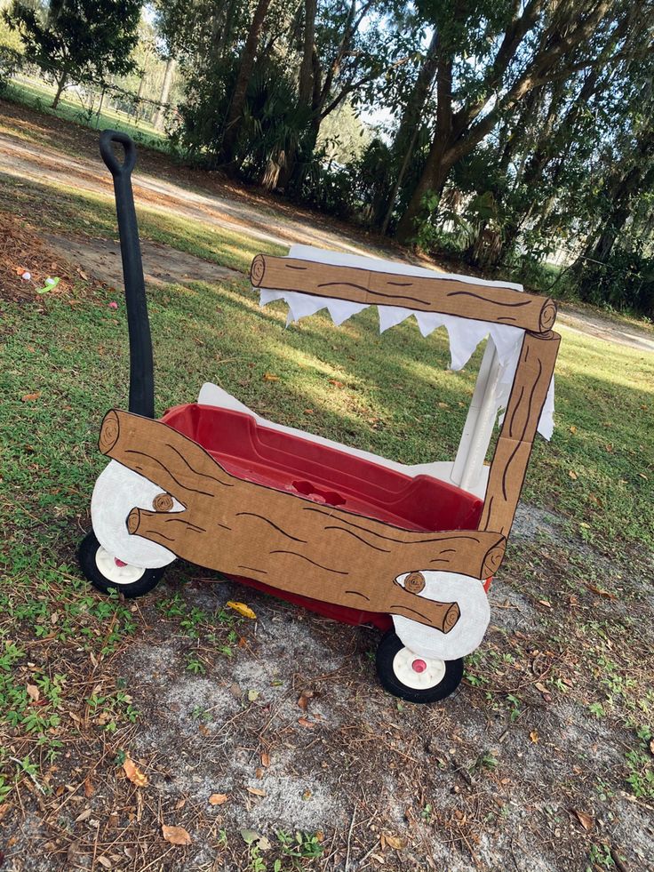 a wagon made out of cardboard sitting in the grass