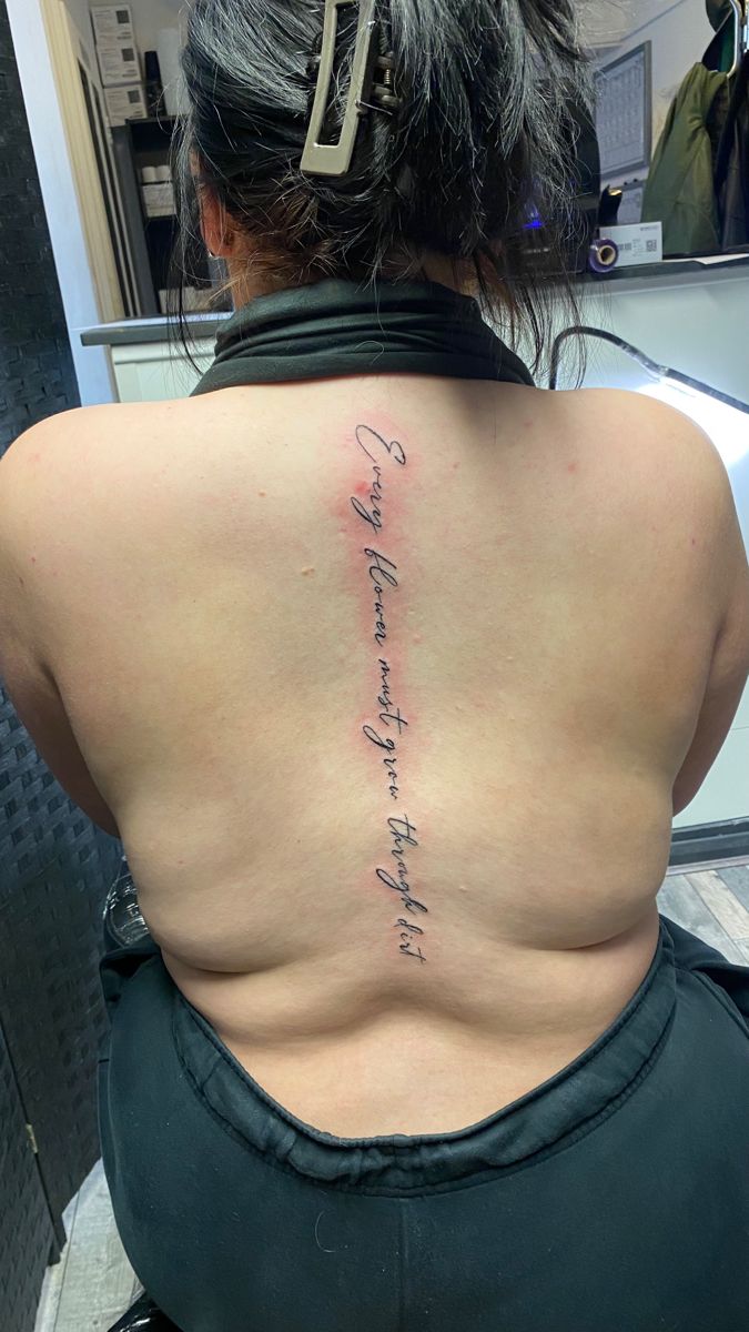 the back of a woman's lower back tattoo