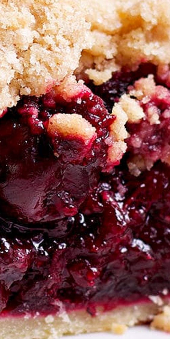 a close up of a piece of pie on a white plate with crumbs