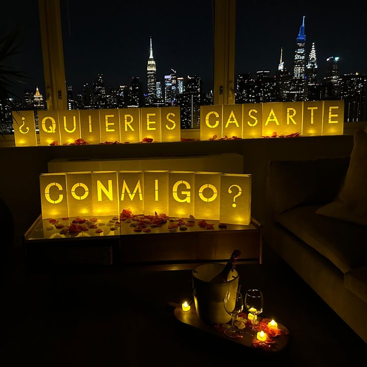 candles lit up in the shape of letters that spell out'conmigo?