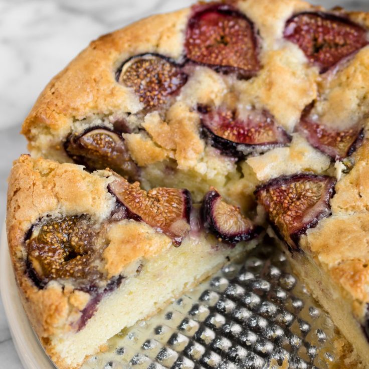 a close up of a cake on a plate with a slice missing from the pie