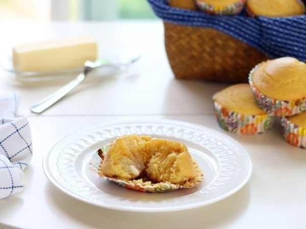 a muffin on a plate with some other muffins in the back ground