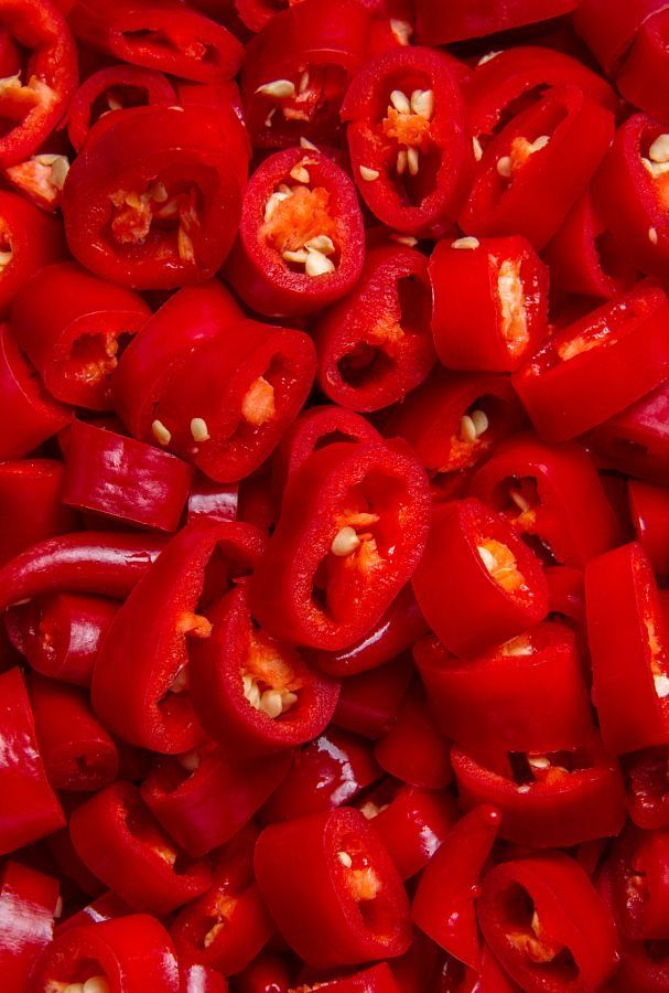 closeup of red peppers with nuts on them