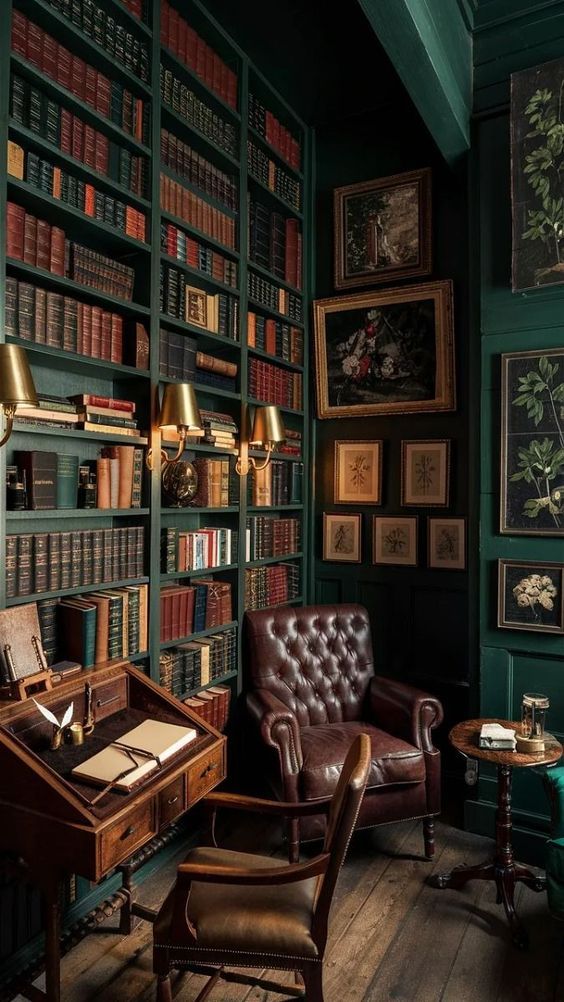 a room with green walls and lots of bookshelves filled with old fashioned furniture